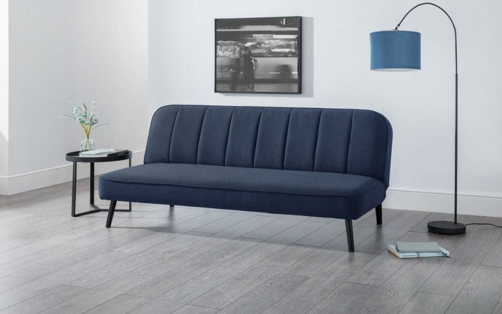 Elba Curved Back Sofa Bed Blue with Coffee Table and Floor Lamp in Living Room Setting