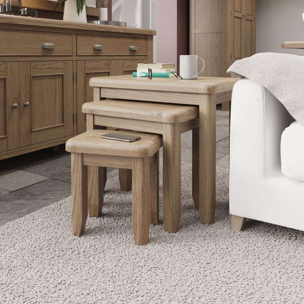 Haven Square Nest of 3 Tables in Warm Oak Finish with Wooden Cupboard and Sofa in Living Setting