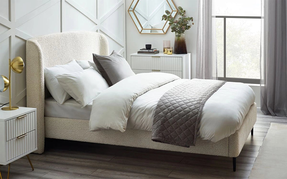 Adam Boucle Bed in Ivory Finish with Wall Mirror and Gold Lampshade in Bedroom Setting