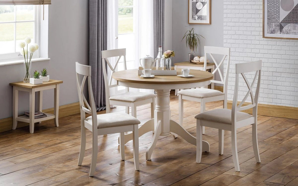 Davina Oak Top Round Pedestal Dining Table in Ivory Leg Finish with Padded Wooden Chairs and Transparent Glass Vase in Dining Setting