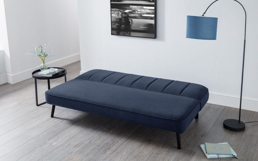 Elba Curved Back Sofa Bed Blue with Coffee Table and Floor Lamp in Living Room Setting 2