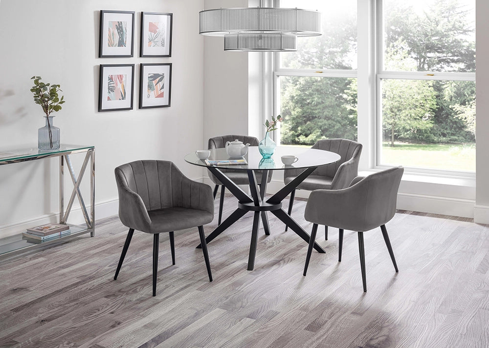 Jayden Round Dining Table in Glass Top with Padded Grey Tub Chairs and Tansparent Vase in Breakout Setting